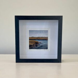 ?. A black frame with a picture of a river.