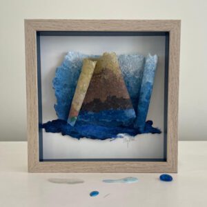 Available, July 2025. Framed abstract paper art with blue hues.